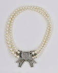 Miu Miu shiny bow and pearly necklace