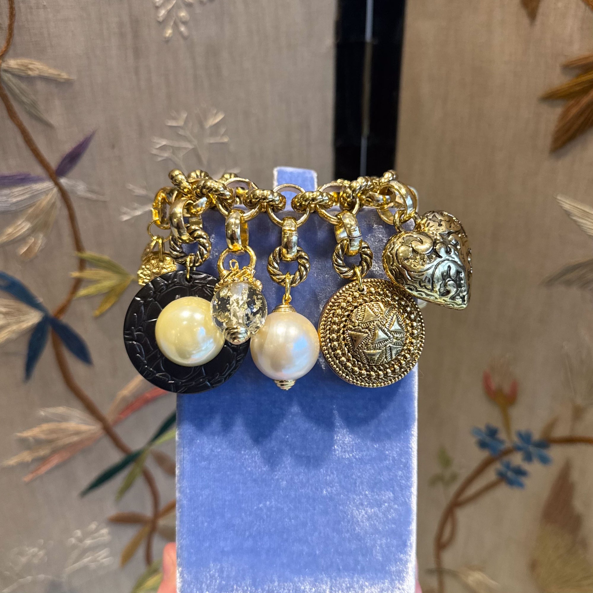 Bold golden bracelet with charms