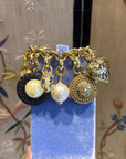 Bold golden bracelet with charms