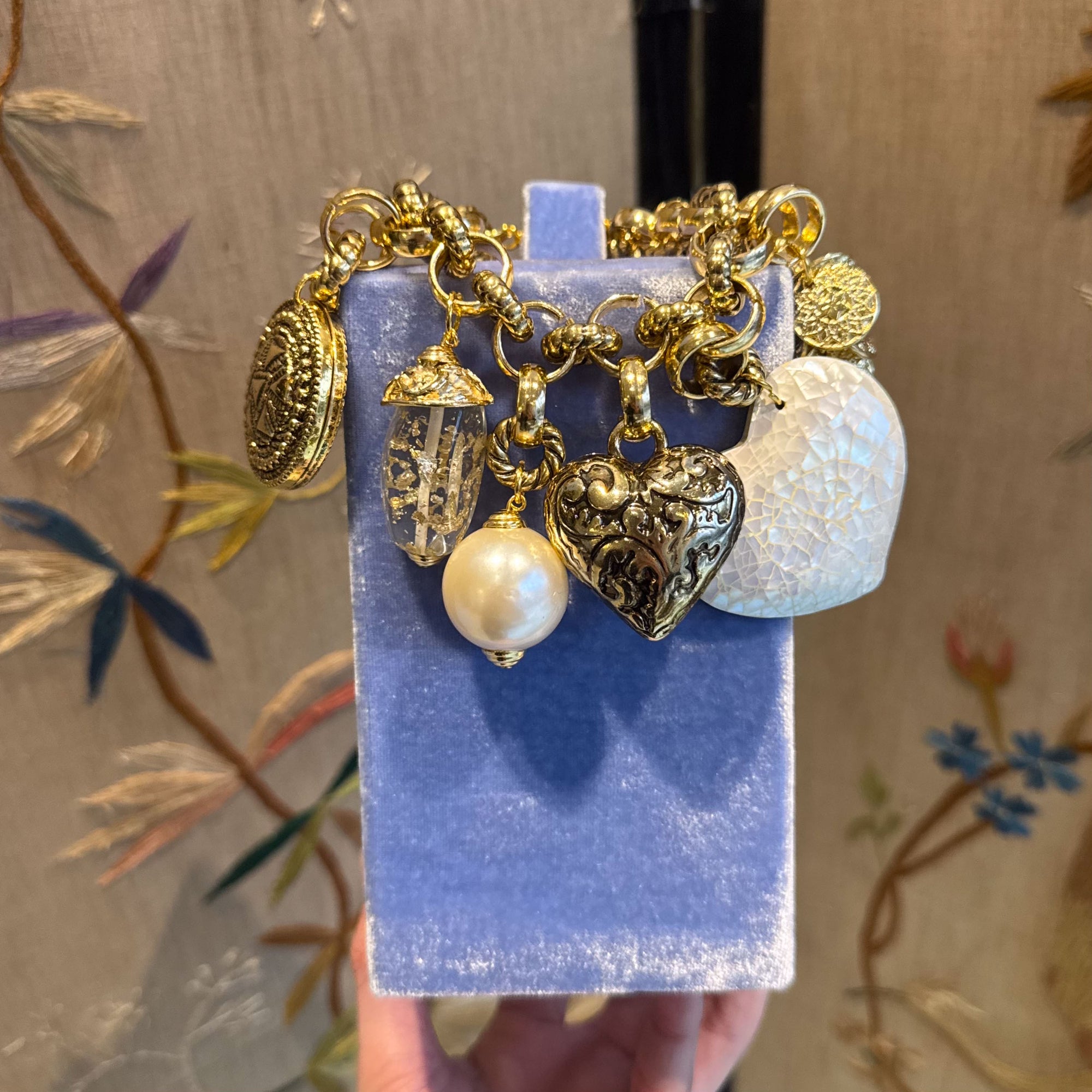 Bold golden bracelet with charms