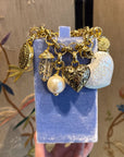 Bold golden bracelet with charms