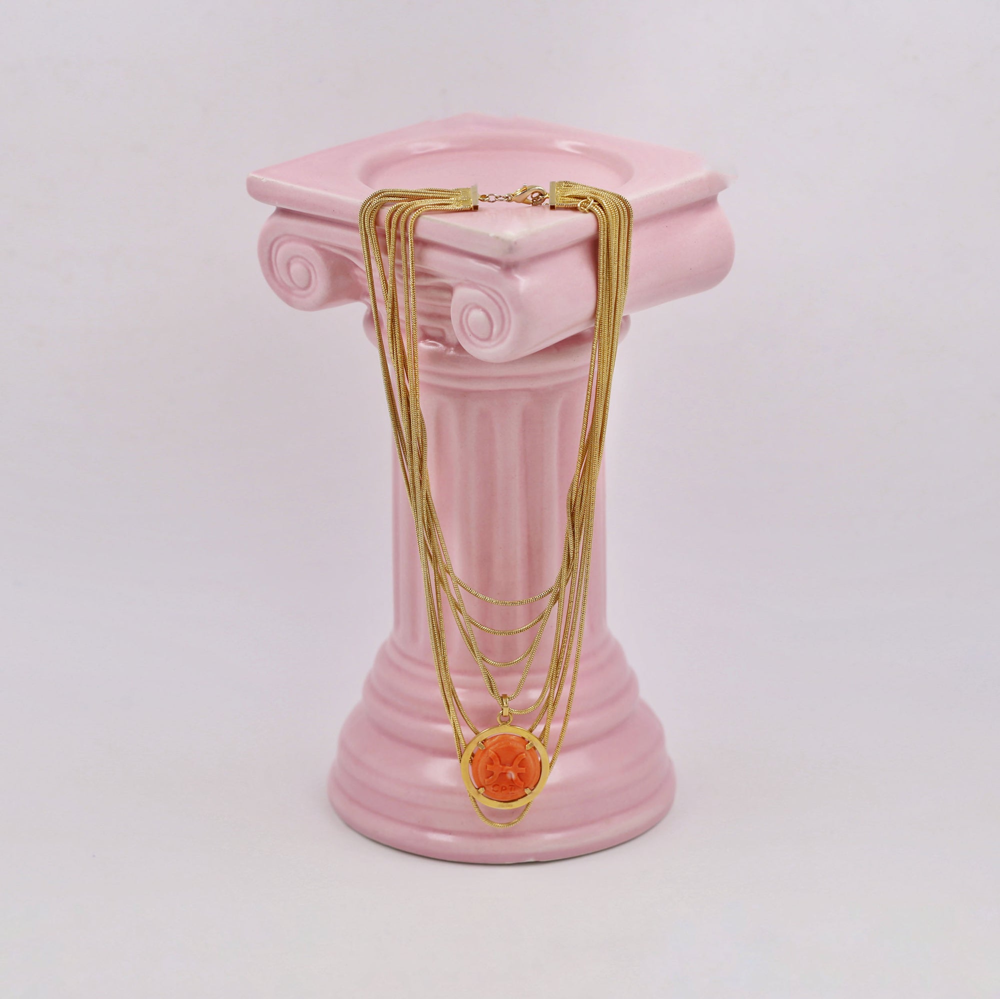 Gold-plated multi-layered necklace with a coral pendant