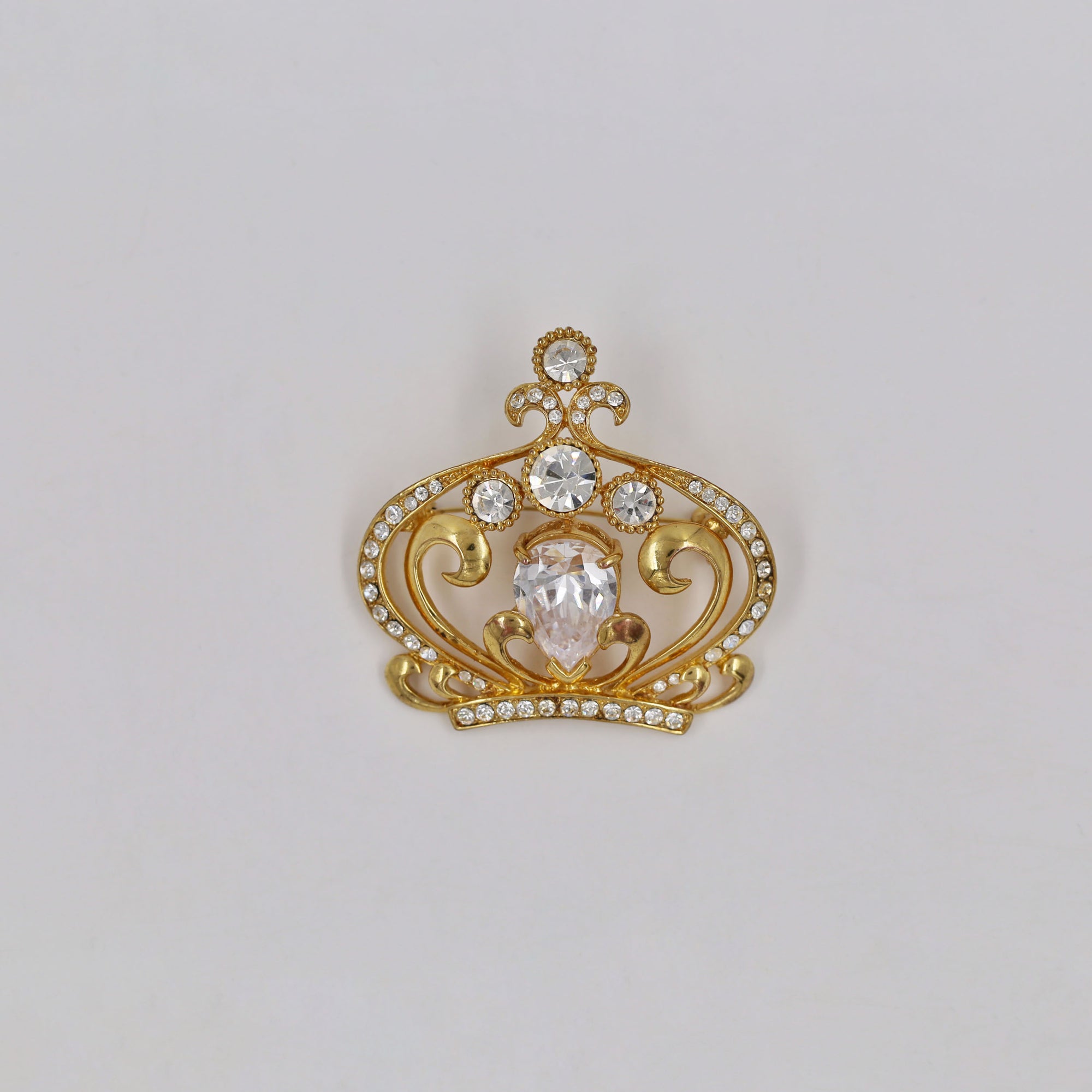 Shiny golden crown brooch
