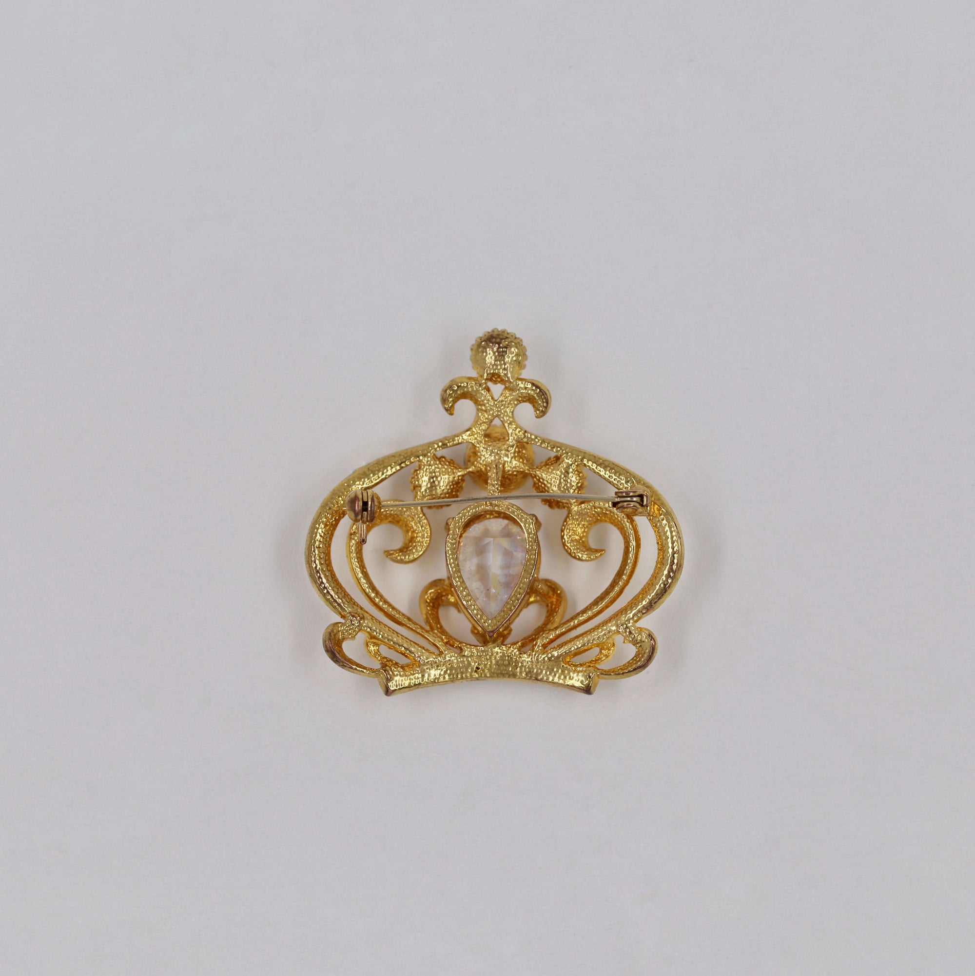 Shiny golden crown brooch